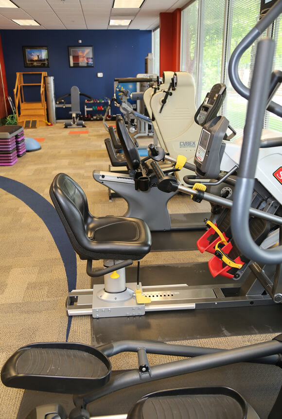 A Genesis therapist helping a patient stretch during rehabilitation